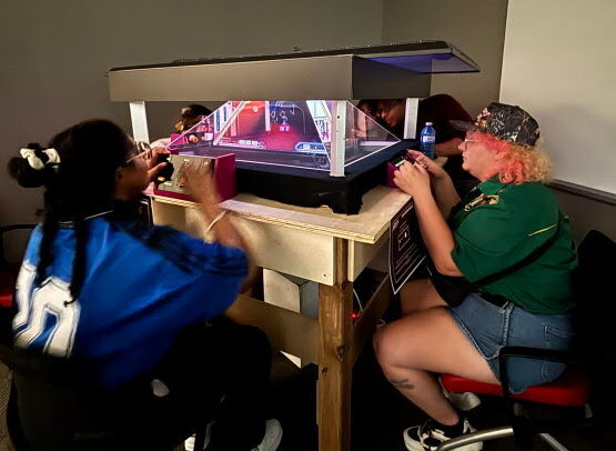 Two players face off at a tabletop arcade cabinet